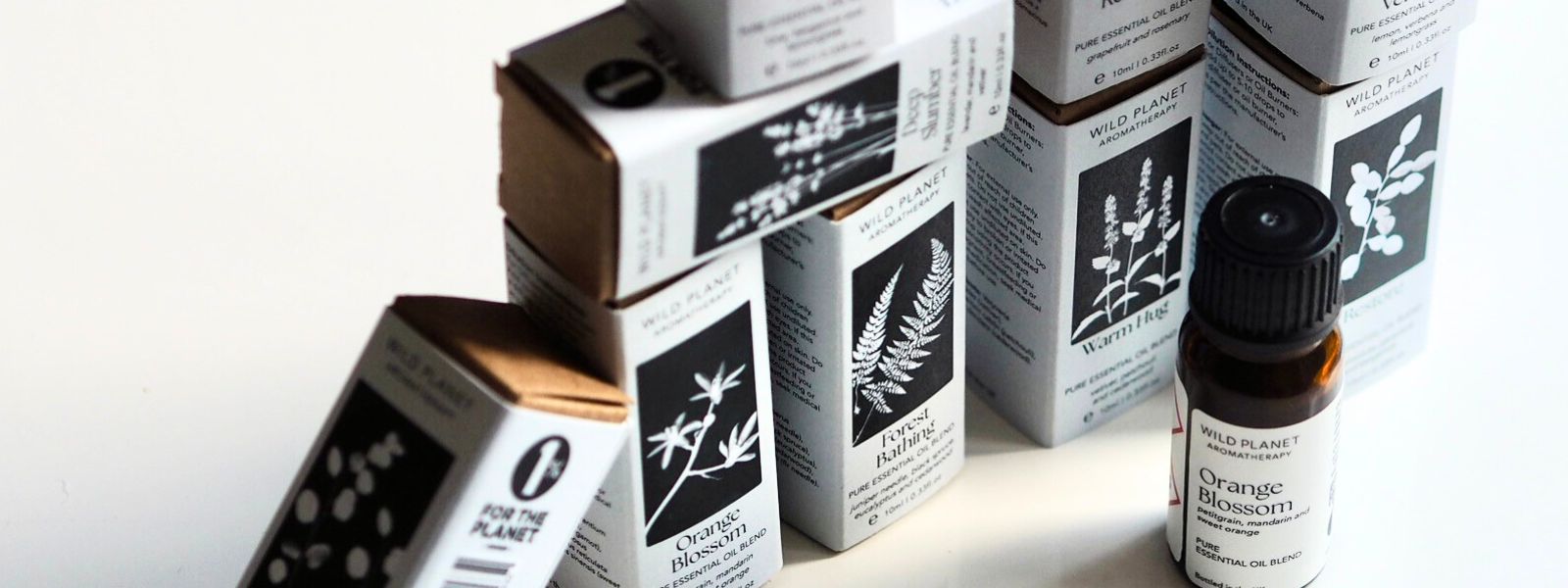 Collection of essential oil blend 10ml boxes and Orange Blossom amber glass 10ml bottle by Wild Planet Aromatherapy