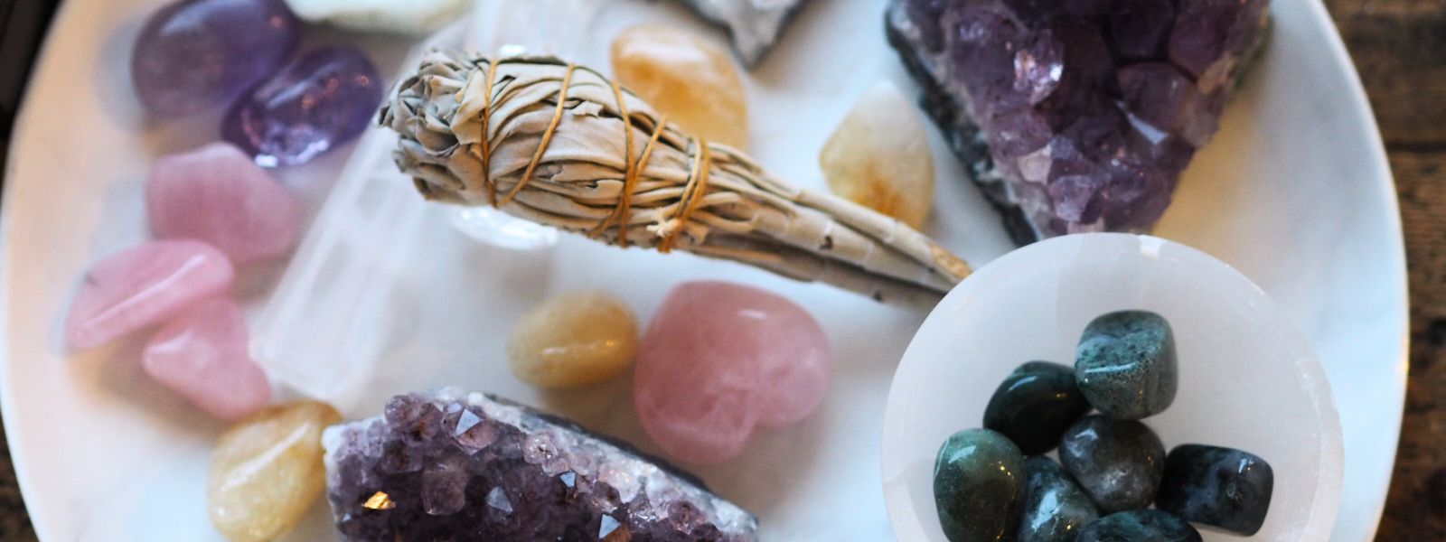 Selection of crystals including rose quartz, amethyst, green moss agate and a white sage smudge stick