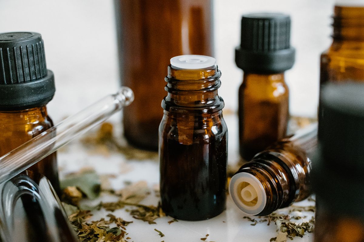 amber glass bottles of essential oils and glass pipette