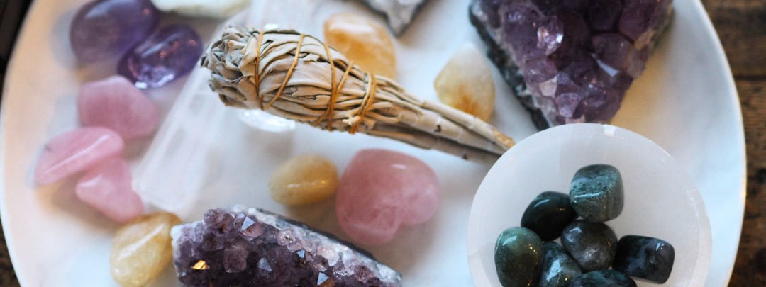 Selection of crystals including rose quartz, amethyst, green moss agate and a white sage smudge stick