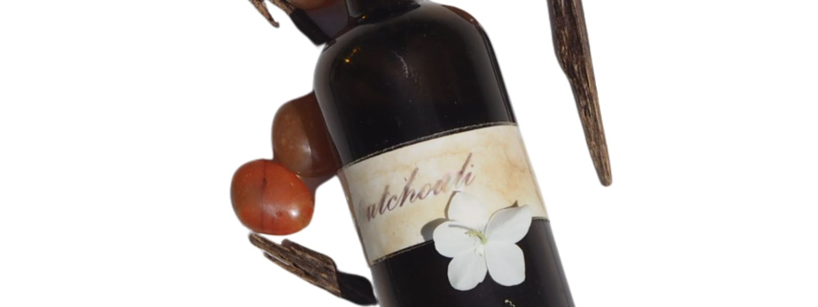 crystals, patchouli amber glass bottle, white flower ingredients for Hedonist fragrance