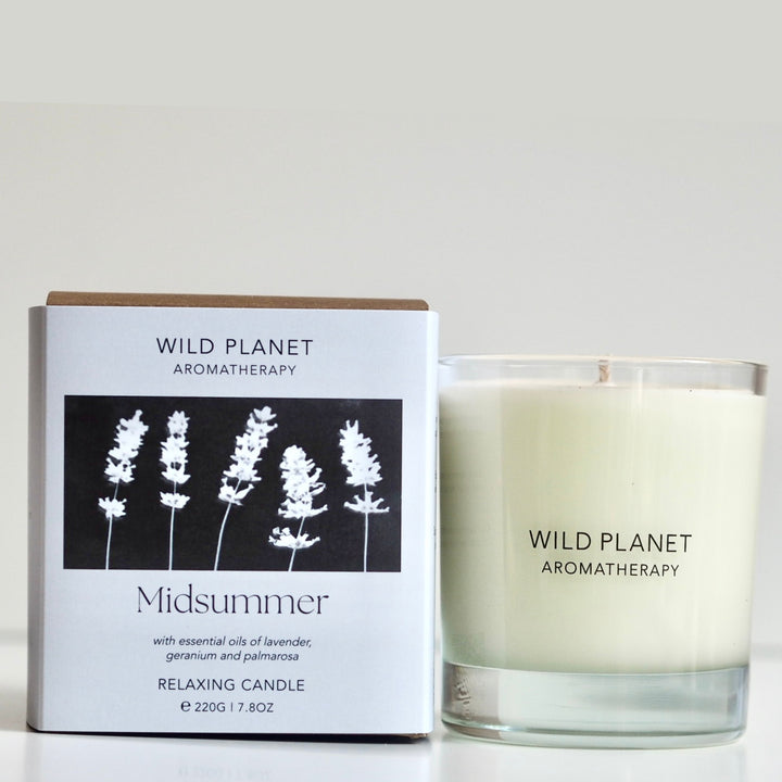 Wild Planet Aromatherapy relaxing vegan natural soy wax candle next to natural eco friendly box 