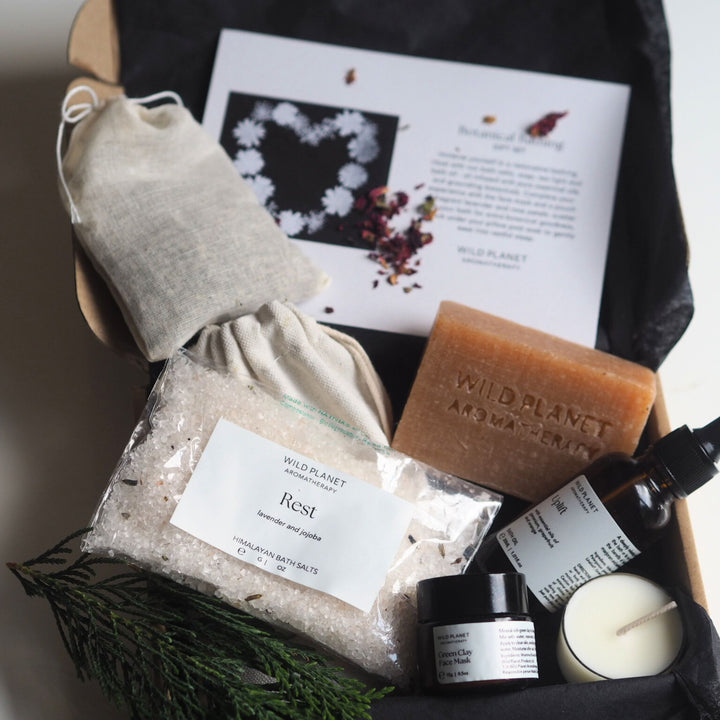 Lavender and roses in cotton bag, bath salts, bath oil, soap bar, tea light in open box, insert card