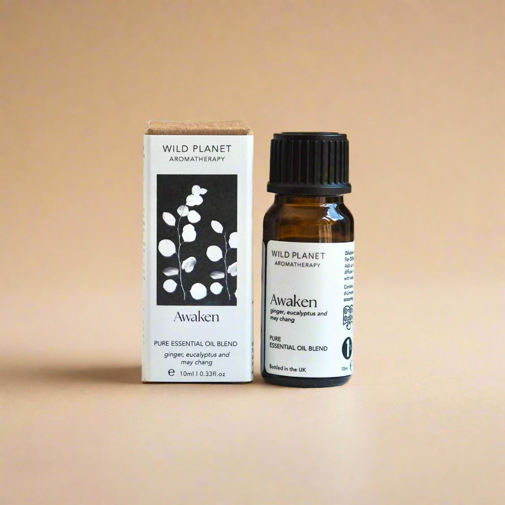 Awaken reviving essential oil blend bottle and box on beige background by Wild Planet Aromatherapy