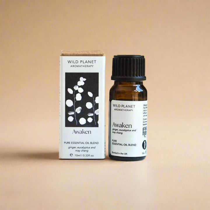 Awaken reviving essential oil blend bottle and box on beige background by Wild Planet Aromatherapy