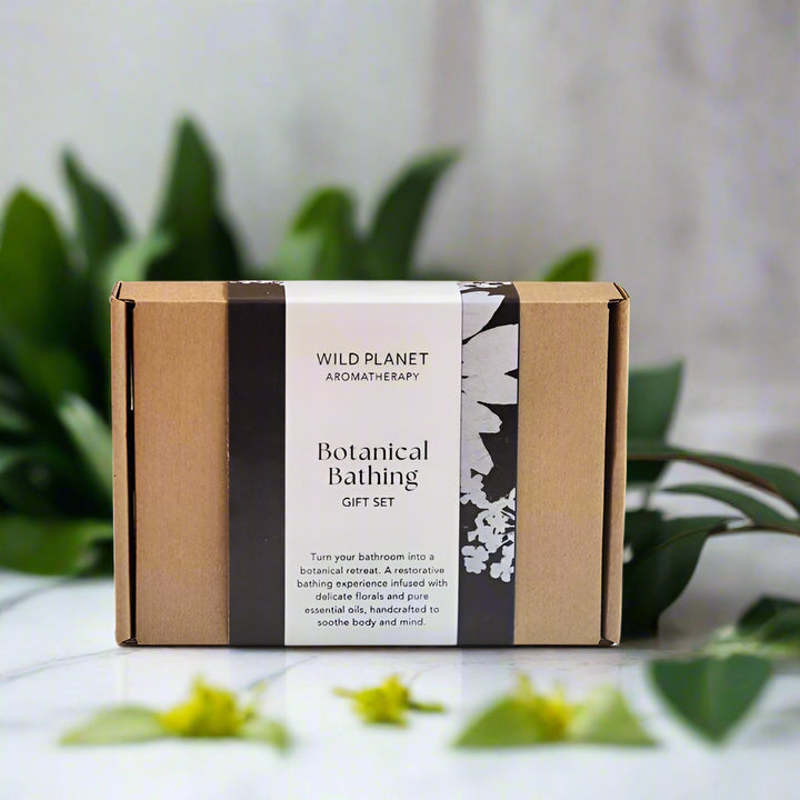 Botanical Bathing Gift Set box next to plants and leaves by Wild Planet Aromatherapy