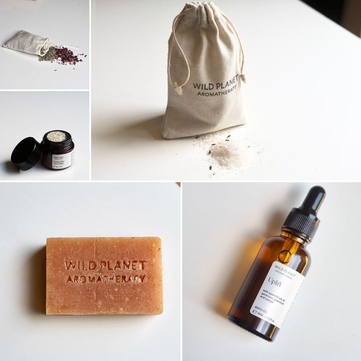 Lavender and roses in cotton bag, bath salts, bath oil, soap bar, tea light on white background